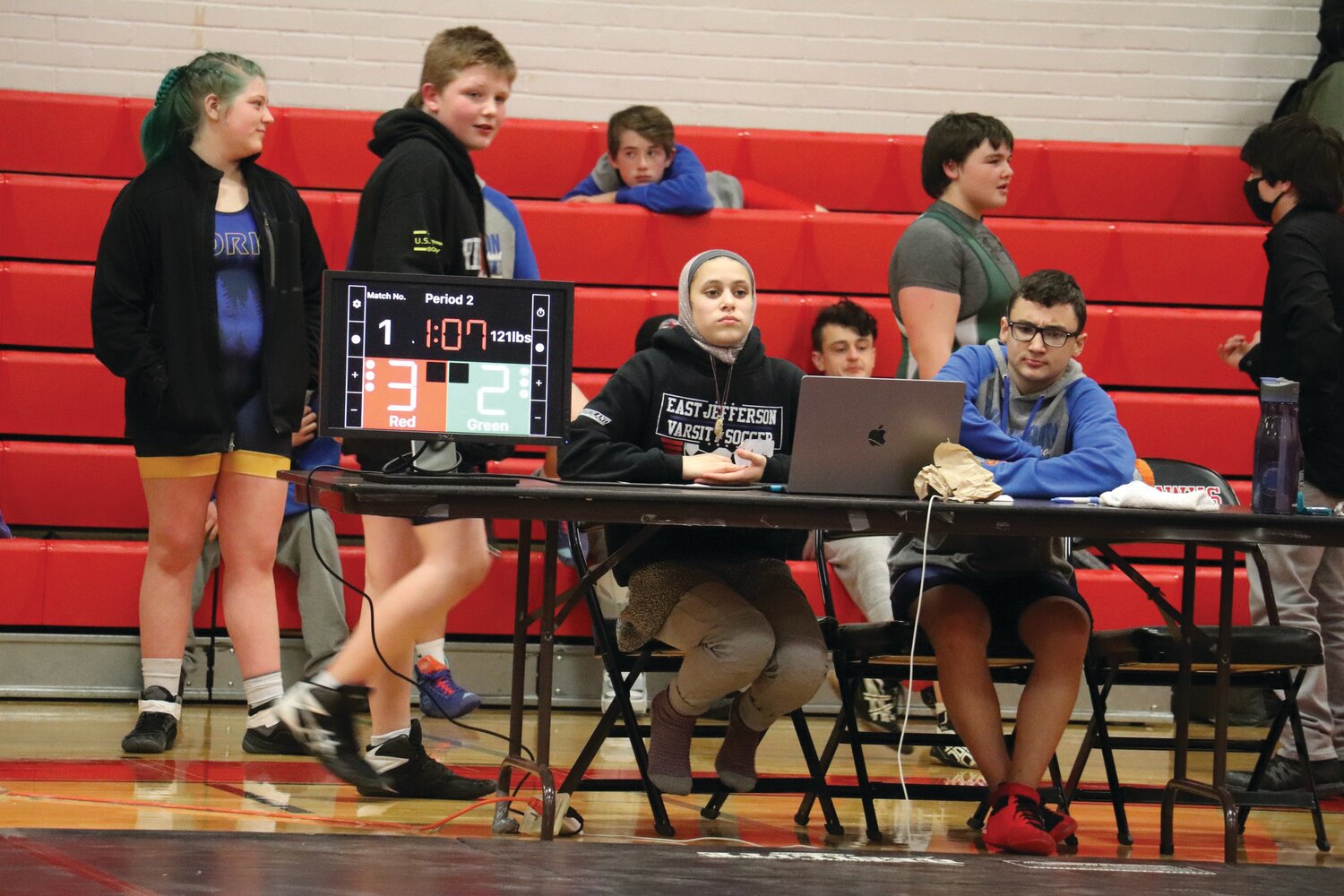 Mi Amada Lanphear Ramirez and Blue Heron Middle eighth-grader Damien Ilarraza run the score table at a middle school meet, with Lanphear Ramirez operating as assistant coach for the youth grapplers throughout the season.